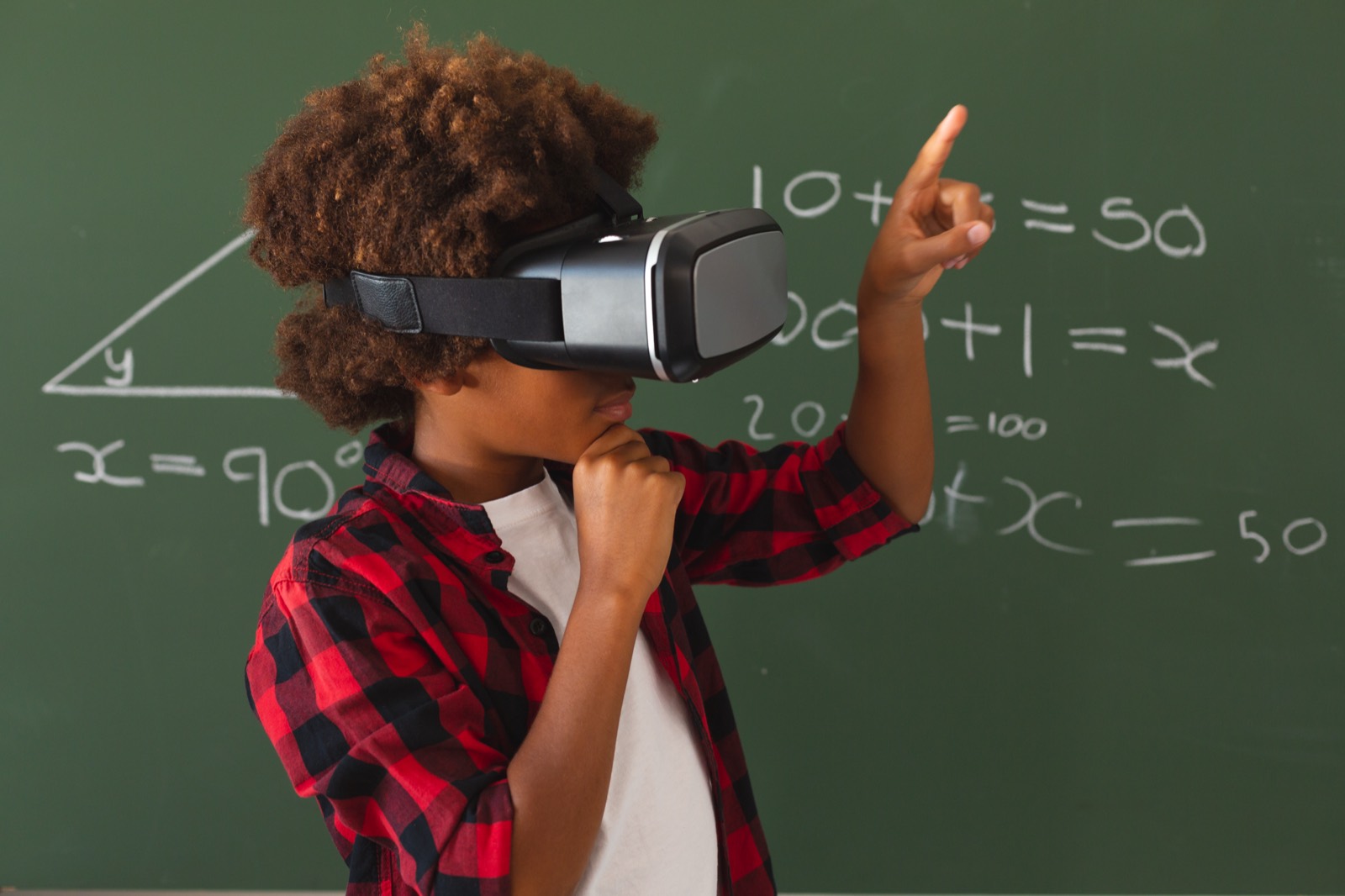 A pupil using a virtual reality headset in a maths lesson
