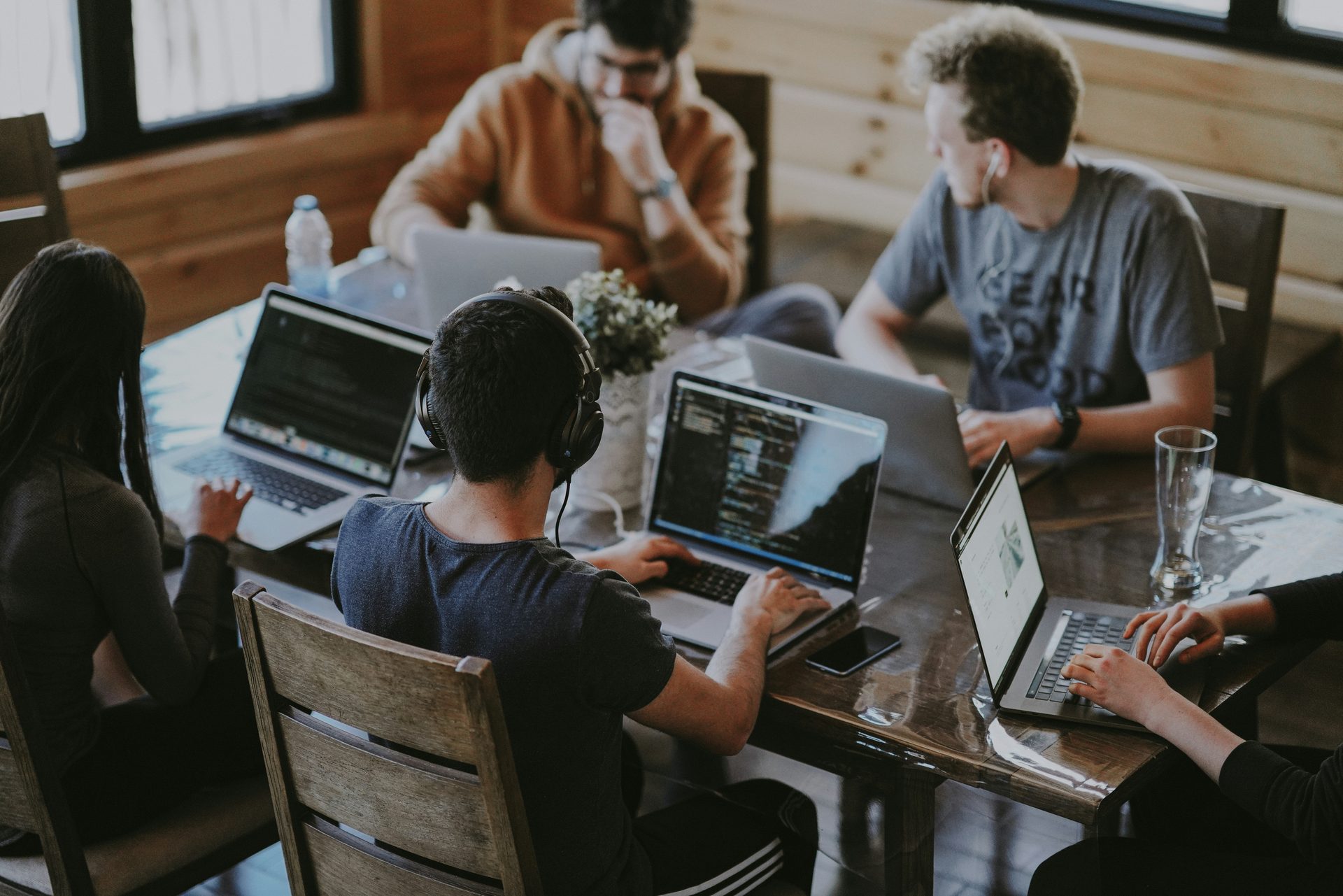 The development team collaborating around a table with laptops