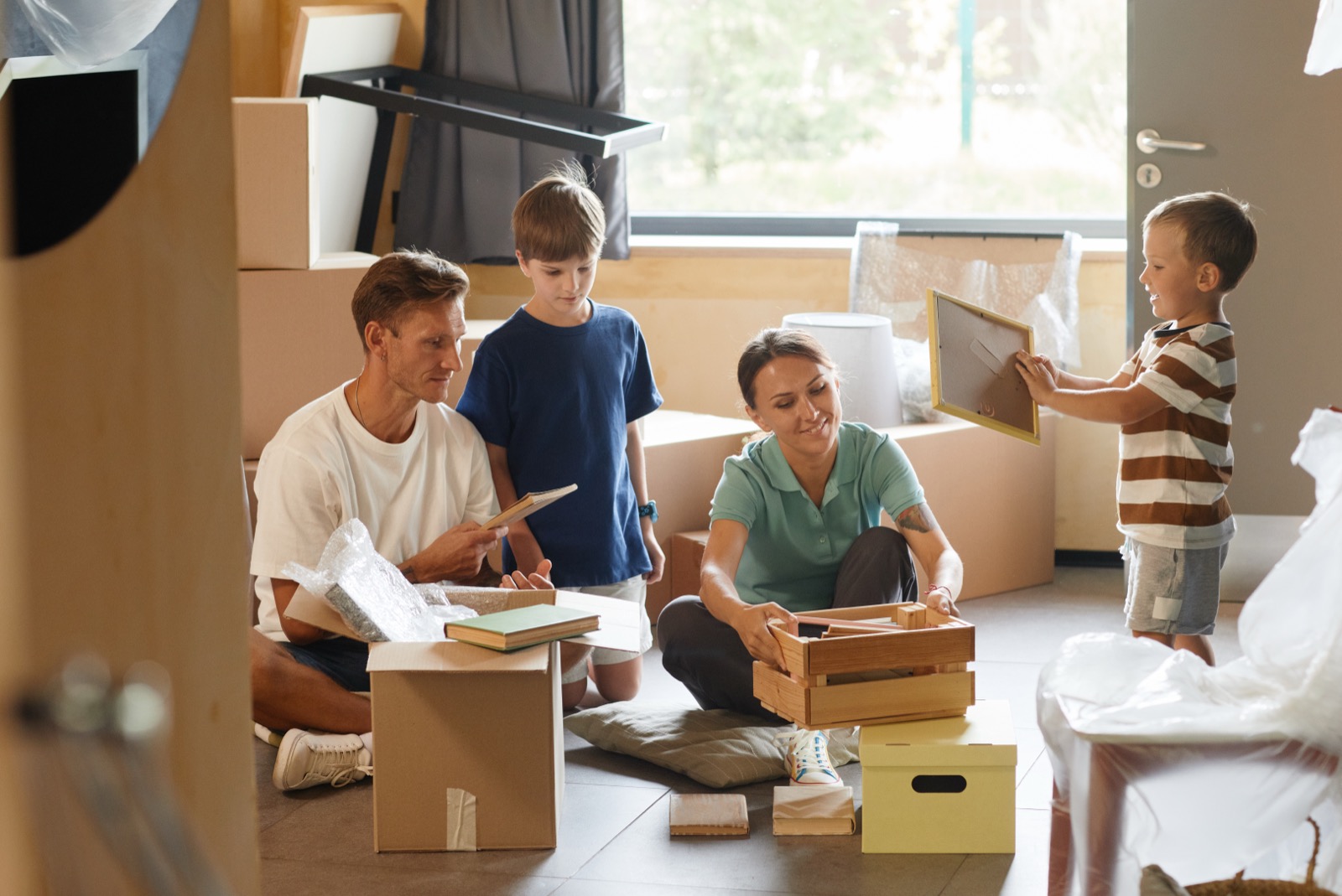 A family moving boxes into a new home