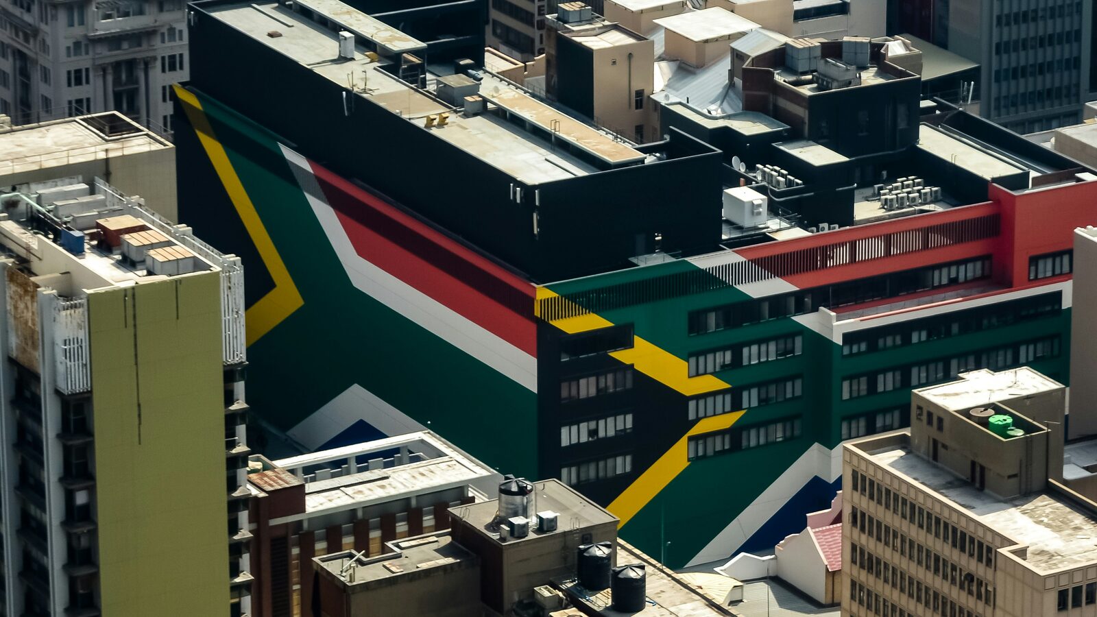 An aerial view of the Johannesburg CBD, the South African flag painted across a building