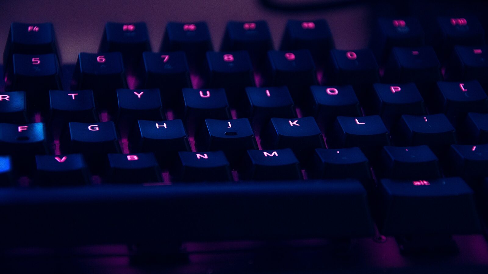 A backlit keyboard in a darkened room